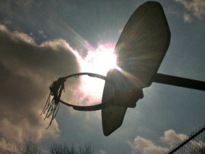 Photo: Sun shining through basketball hoop