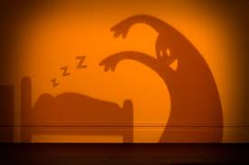 Image: shadow of bogeyman leaning over sleeping child 