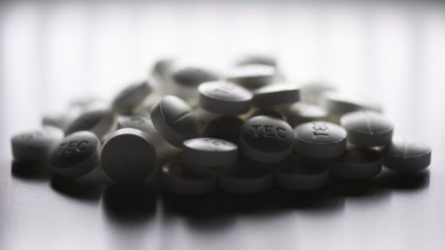 Image of a pile of black pills.